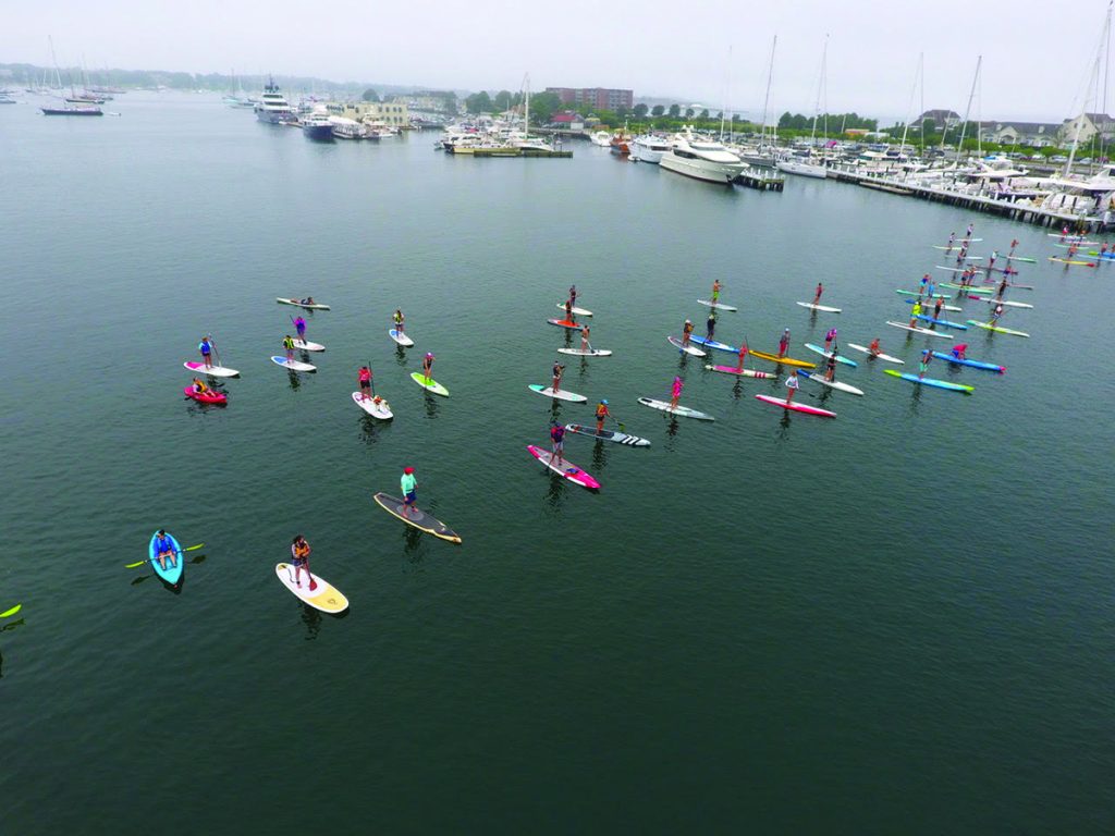 Paddle for Access racers line up for the start by Safe Harbor Newport Shipyard. © cleanocaenaccess.org